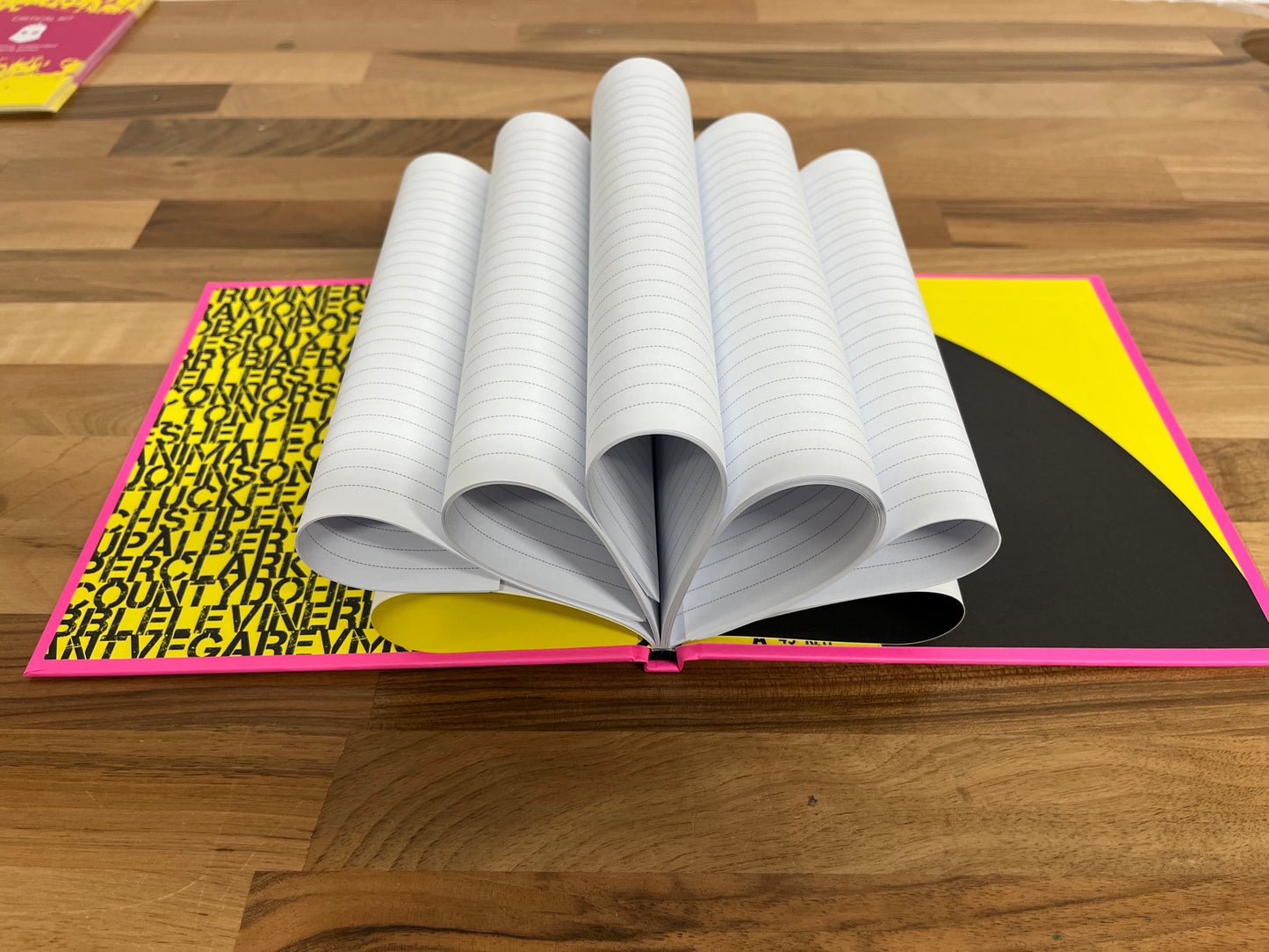 Open book with a colorful cover on a wooden surface
