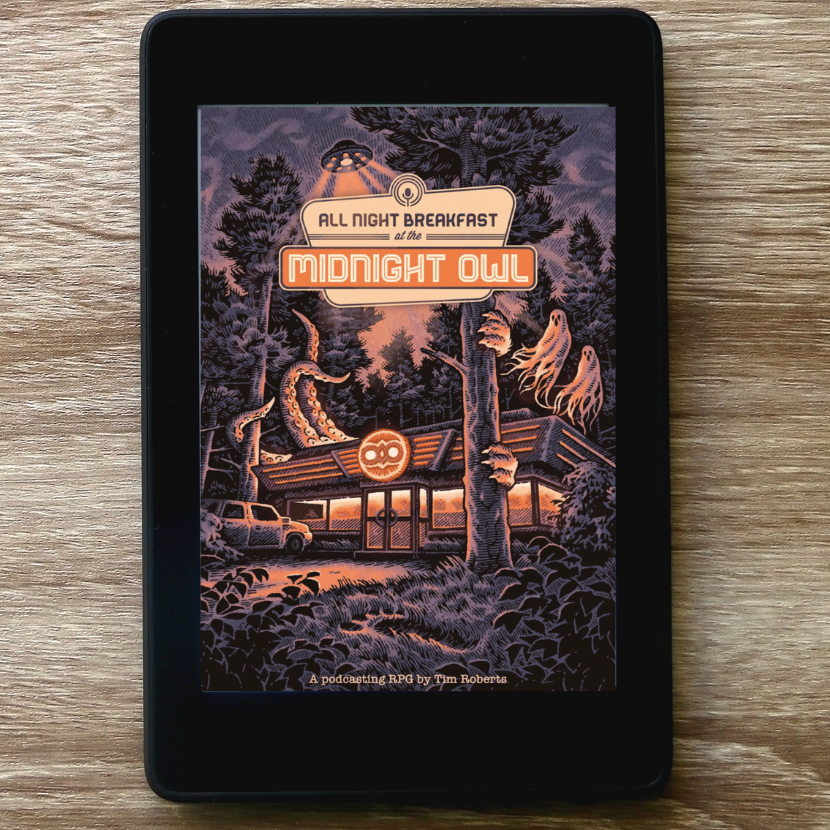 A black e-reader or tablet displaying the cover art for 'All Night Breakfast: Midnight Owl' solo rog on a light brown wood-grain surface.