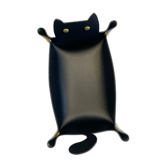 A black cat-shaped dice tray with small gold-coloured eyes and paw-pad accents, photographed against a plain white background.