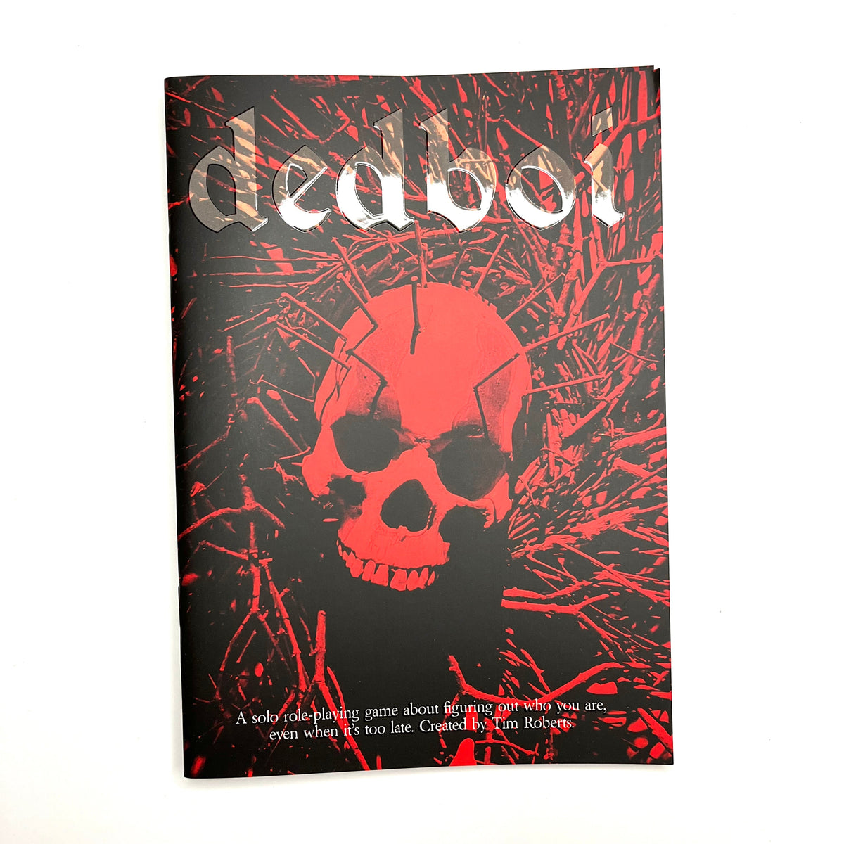 A book titled 'dedboi' with a black cover featuring a red skull and red splatter graphics, photographed against a plain white background.