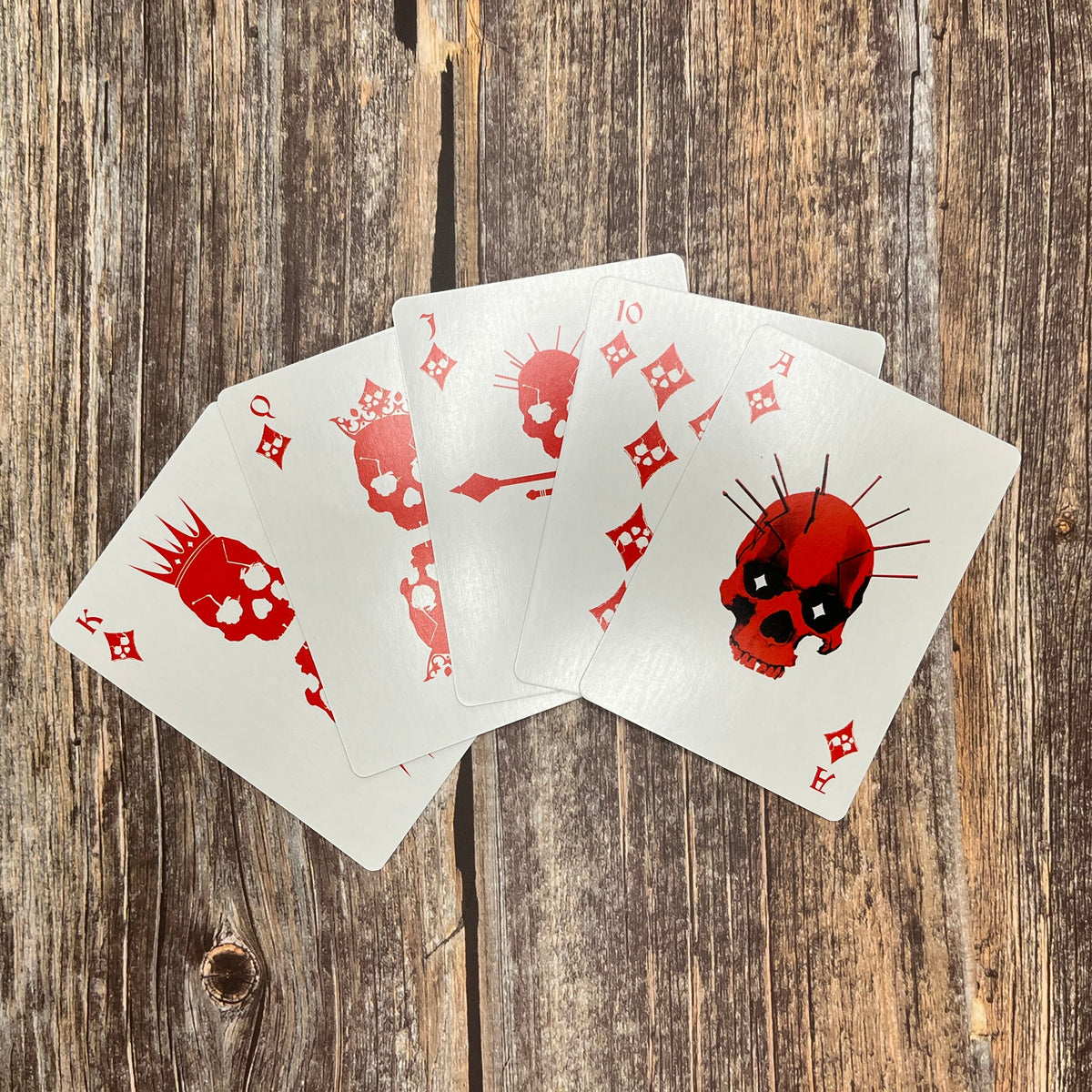 Red diamond court cards from a poker deck with skull designs