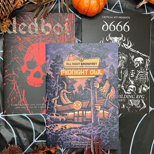 halloween decorations surrounding three rpg books dedboi, all night breakfast and d666 for spooky solo journaling game
