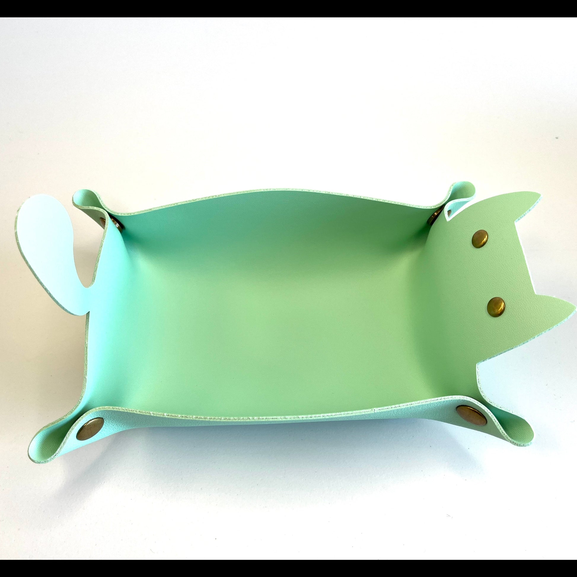 A mint green cat-shaped dice tray with small gold-tone metal studs, photographed from a top-down angle on a clean white background.