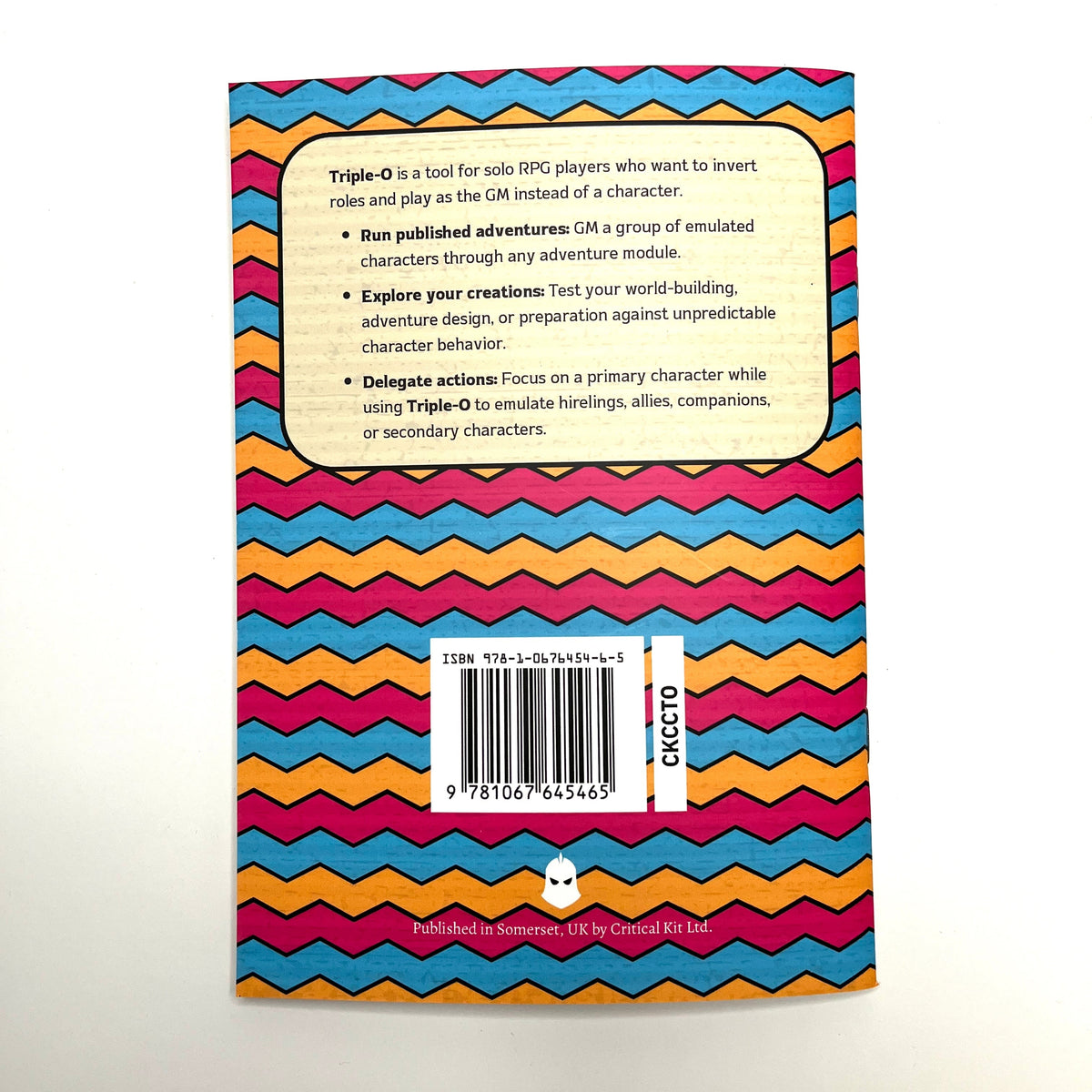 The back cover of a board game box for Triple-O, featuring a colorful chevron pattern in pink, orange, yellow, green, and blue, with a white text box and a barcode.