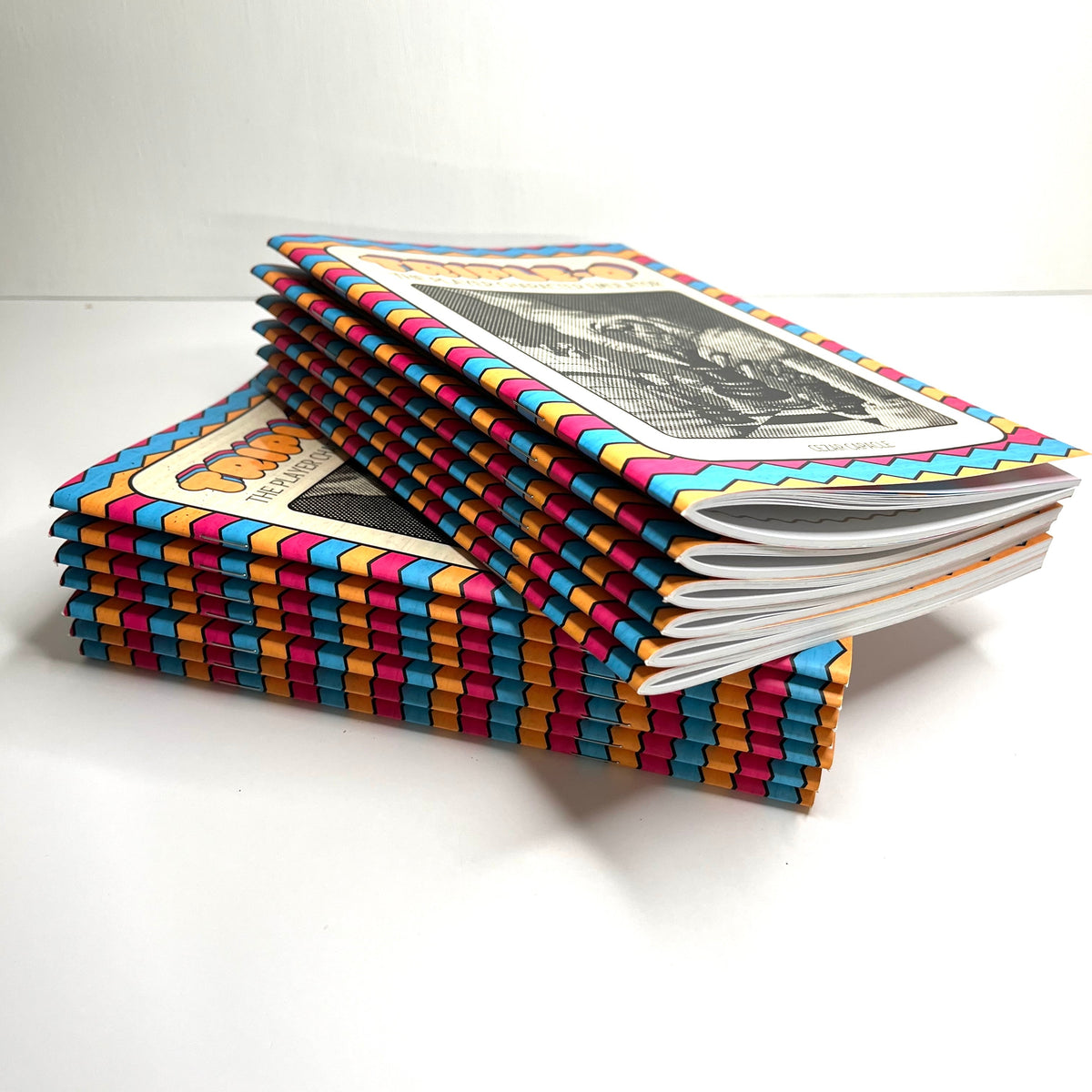 Stack of Triple-O books with a rainbow spine